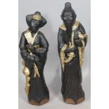A pair of reproduction carved oriental figures, 80cm high.