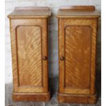 A pair of late Victorian satinwood bedside cabinets, with one part galleried backs, moulded front