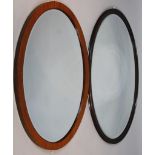 An oval hanging mirror, with bevelled glass and mahogany finish frame of plain outline, 74cm x 97cm,