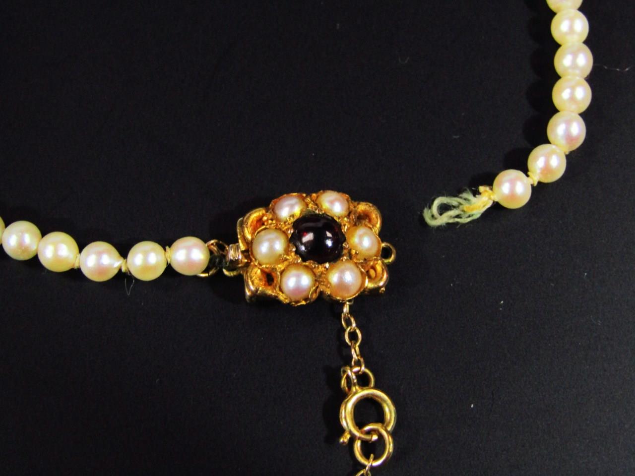 A ladies graduated pearl necklace, with elaborate 9ct gold clasp, set with further pearls and red - Image 2 of 5