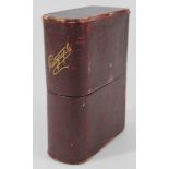 An early 20thC leather photograph album, formed as an articulated book, opening at the centre with