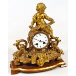 A late 19thC gilt metal mantel clock, the 10cm dia. Roman numeric dial with eight day movement