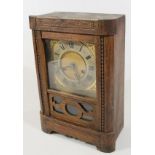 An early 20th century oak cased mantel clock, the Roman numeric dial, before a 16cm wide back