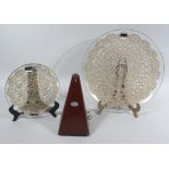 A 20thC Paquet metronome, of tapering outline, 25cm high and two graduated Parlane glass dishes. (