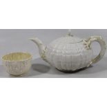 An early 20thC Belleek porcelain teapot, with double tree work handle, shell shaped body, shaped