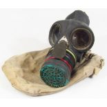 A gas mask in canvas pouch, 30cm high.