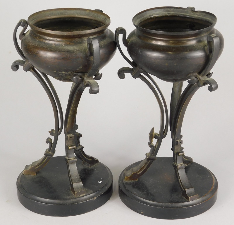 A pair of 19thC bronze urns, on swept supports, ebonised wooden bases, 30cm high. - Image 2 of 2