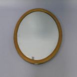 A gilt framed oval wall mirror, with reeded cushion frame, 58cm x 82cm overall.