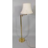 A brass angular stand and lamp, 145cm high and a mesh fire guard, (2).