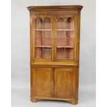 A George oak standing corner cabinet, with glazed upper section, enclosed by two doors with plain