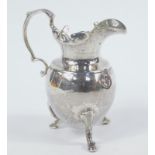 A George III silver cream jug, with a shaped spout and acanthus leaf thumb mould handle, the bulbous