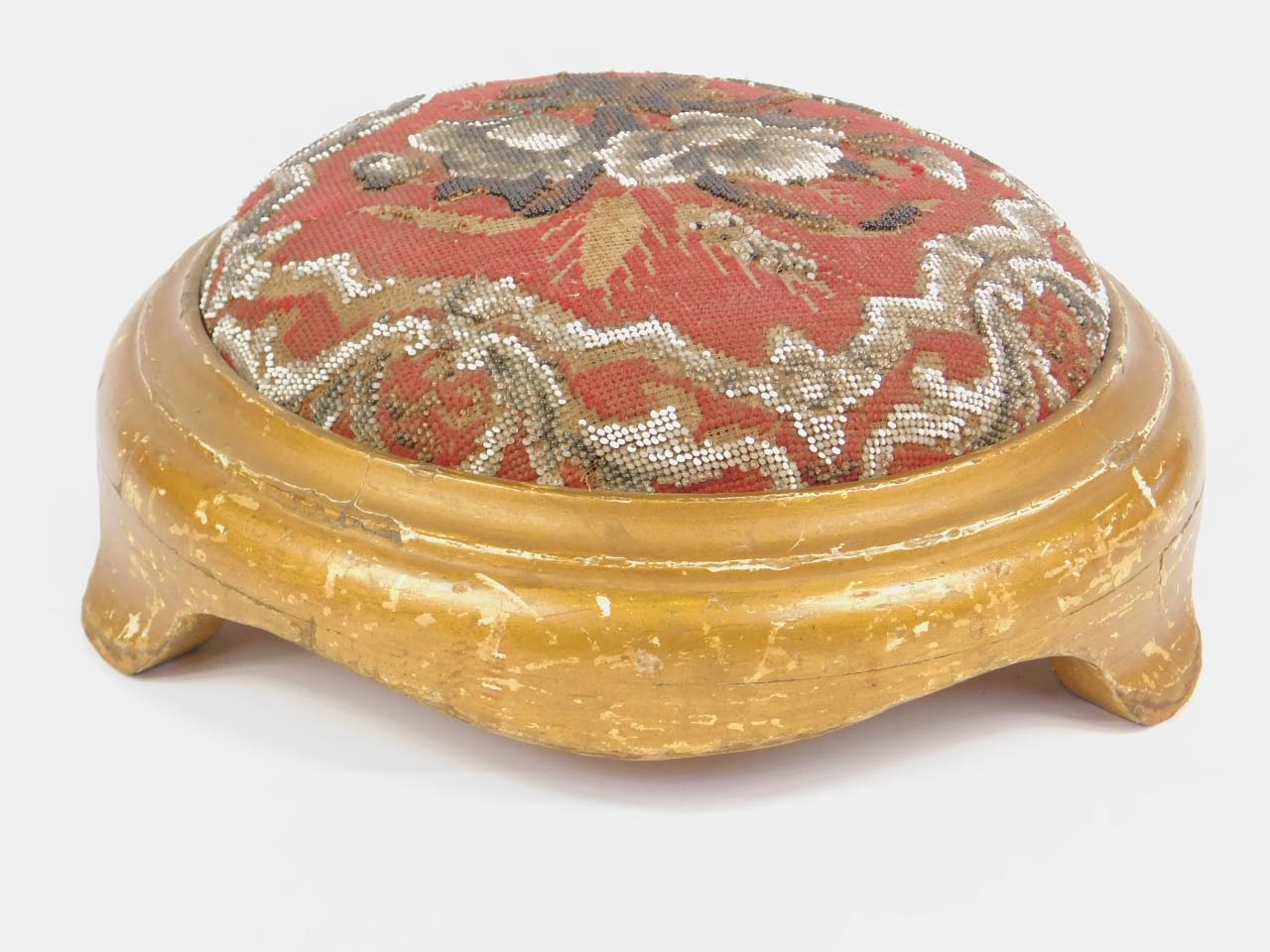 A Victorian giltwood foot stool, with a floral decorated wool and bead work upholstery, 32.5cm