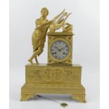 An early 19thC French ormolu mantel clock, with a lyre playing figure leaning to a silvered dial