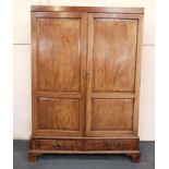 A George III mahogany wardrobe, with two drawers below, and later replacement cornice, 138cm wide,