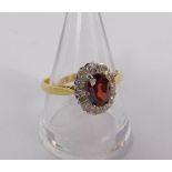 An 18ct gold red stone and diamond set ring, possibly a spinel, in an opal design, size Q, 4.0g.