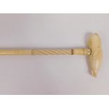 An early 19thC marine ivory and whalebone walking stick, with a whale handle above a wrythen fluted