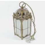 A 20thC brass and frosted glass hall lantern, of lantern clock form, 29cm high.