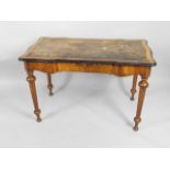 A Victorian walnut and ebonised writing table, the rectangular top with a leather insert and a