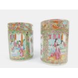 A pair of 19thC Cantonese vases, each squat cylindrical body decorated with panels of figures,