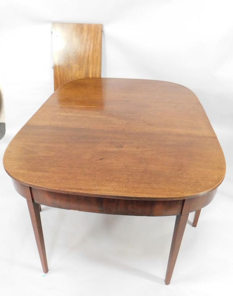 A George III D-end mahogany dining table, with reeded border on square tapered legs with ebony