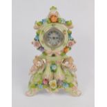 A Continental early 20thC porcelain mantel clock, white metal dial bearing Arabic numerals, the