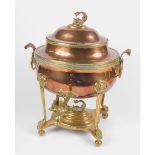 A Regency brass and copper samovar, of oval urn shaped design, with mask head ring handles and