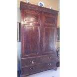 A George III mahogany press cupboard, the top with a dentil and reeded cornice, applied with