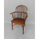 A 19thC oak and elm Windsor chair, with a crinoline stretcher, raised on turned legs.