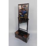 An early 20thC Oriental hardwood toilet mirror, the mirror above a stepped chest of six drawers,