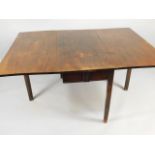 A George III mahogany drop leaf dining table, of rectangular form on channelled square section legs,