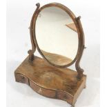 A George III mahogany and chequer banded dressing table mirror, the oval plate on shaped supports