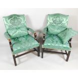 A pair of reproduction mahogany Gainsborough chairs, each upholstered in green damask type material,