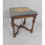 A 19thC William & Mary style oak stool, with tapestry upholstery, raised on turned legs united by an