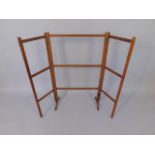 A late 19th/early 20thC mahogany folding towel rail, with slatted supports and shaped base, 113cm
