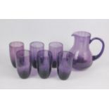 A Portmeirion amethyst glass lemonade set decorated in the Beachcomber pattern, comprising pitcher