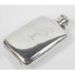 A Victorian silver hip flask by L.G., with shouldered body and hinged lid, the Baines family crest