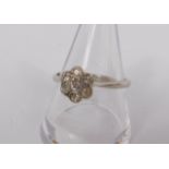 A diamond seven stone flower head ring, set in white metal, stamped 18ct, approx 0.25cts, size P,