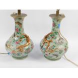 A pair of 19thC Chinese celadon and famille rose vases, the circular body raised with a decorative