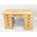 An Edwardian satin walnut kneehole desk, with reeded outline to the graduated drawers with brass