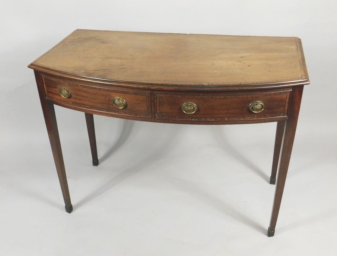 A 19thC mahogany bow fronted side table, with a crossbanded top, above two false frieze drawers