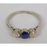 A platinum diamond and sapphire three stone ring, diamonds approx 0.5cts, size Q.