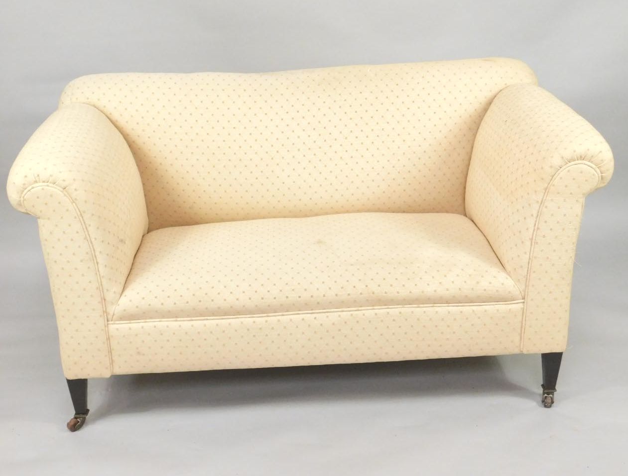 A Victorian settee, with high back and scrolling arms, on square tapered legs and castors, 151cm