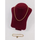 A 9ct gold rope twist neck chain and a 9ct gold cur link bracelet, on a heart shaped padlock