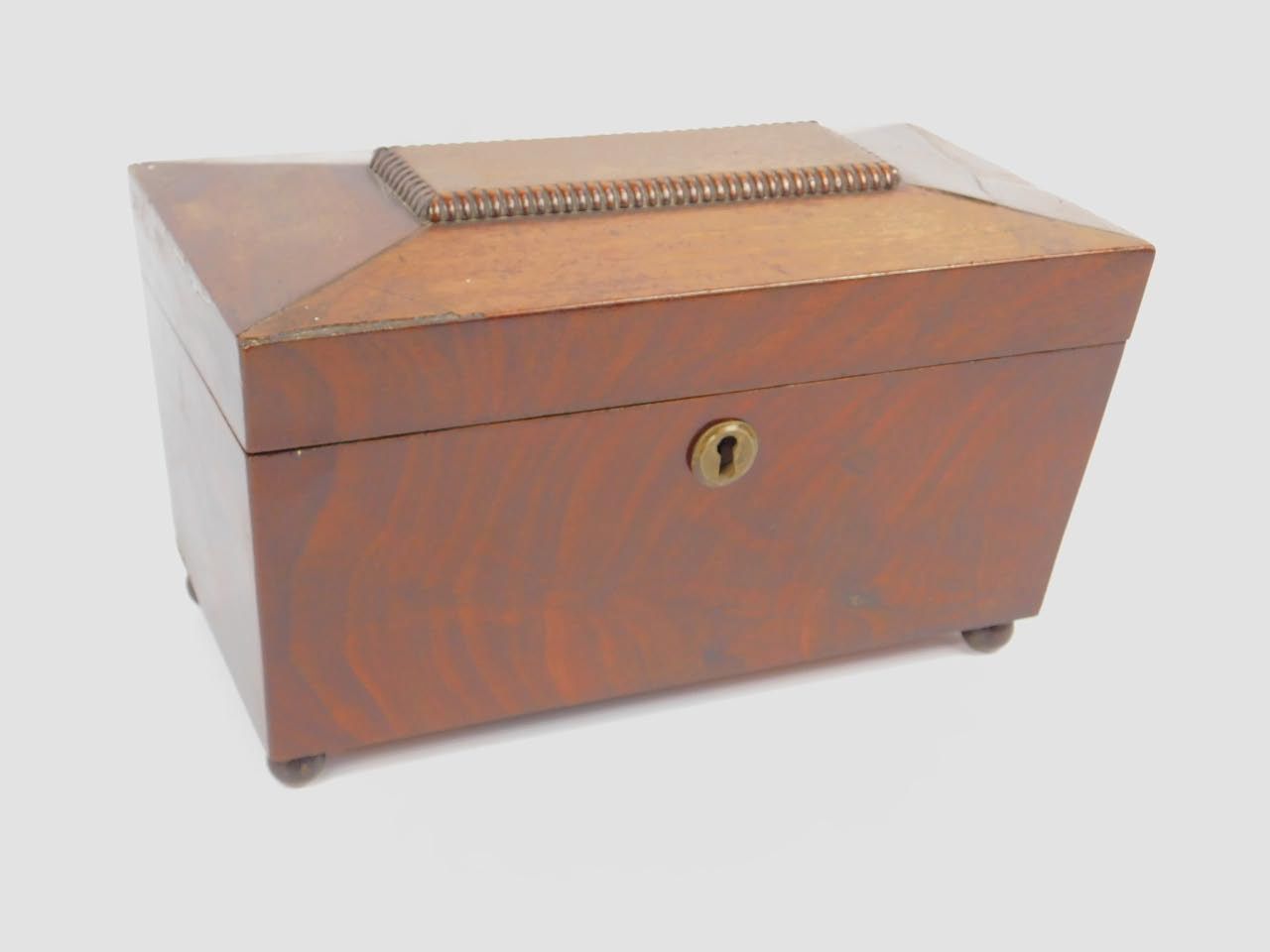 A Regency mahogany sarcophagus tea caddy, with a mixing bowl recess flanked by two tea containers,