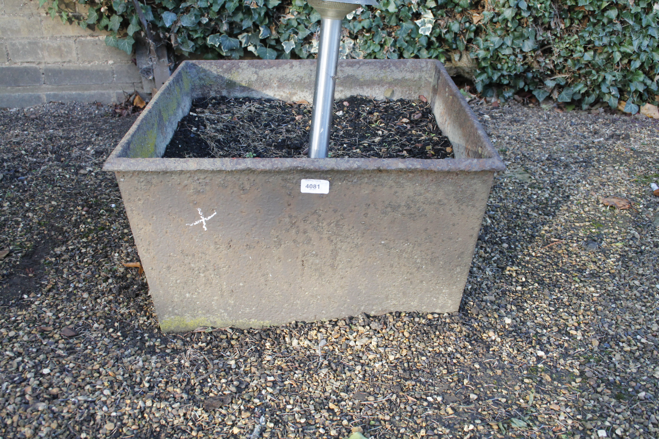 A cast iron trough, 30cm x 54cm x 61cm.