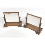 A pair of early Victorian mahogany swing framed dressing table mirrors, the rectangular plate with a