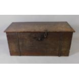 A late 18th/early 19thC Continental oak chest, with a planked top, the base with iron straps and