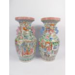 A pair of 19thC Cantonese famille rose porcelain vases, of baluster form with twin Buddhistic lion