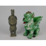 A Chinese Porcelain figural vase modelled as a winged lion, moulded with dragons chasing flaming