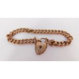 A 9ct rose gold curb link bracelet, on a heart shaped padlock clasp, with safety chain, as fitted,